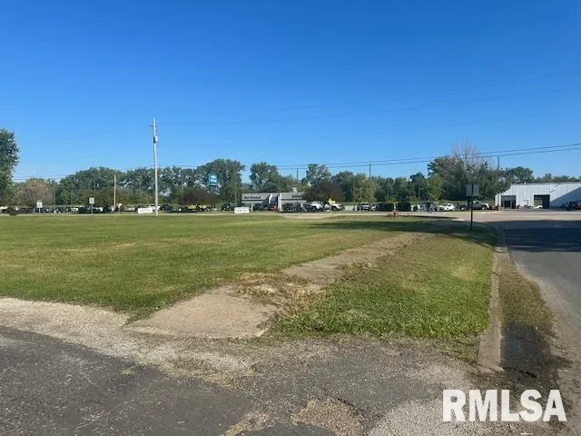a view of a field with an ocean view