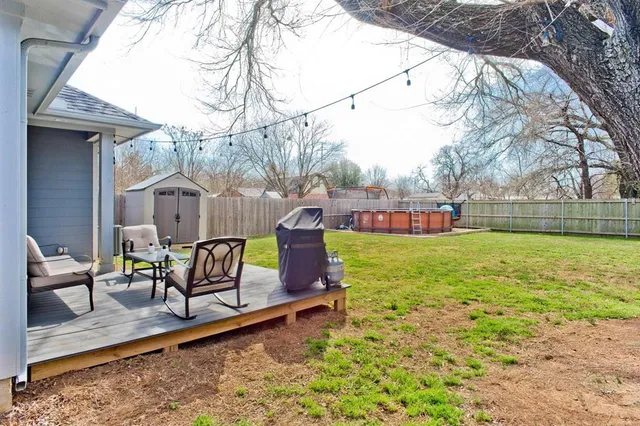 a view of a house with a yard and sitting area