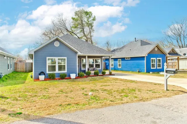 a view of a house with a swimming pool and a yard