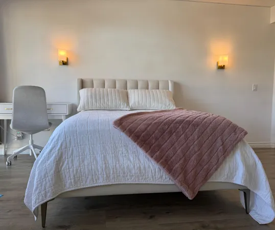 a bedroom with a bed and window