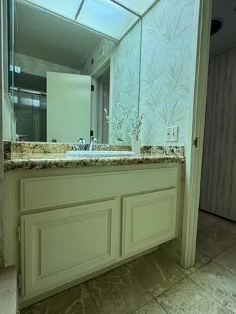 a bathroom with a sink and a mirror
