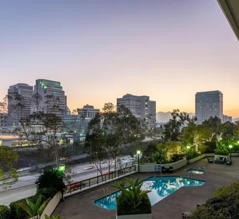 a view of swimming pool with outdoor seating and city view