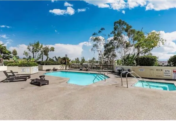 a swimming pool with outdoor seating and yard