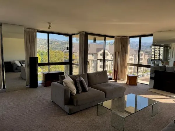 a living room with furniture and a floor to ceiling window