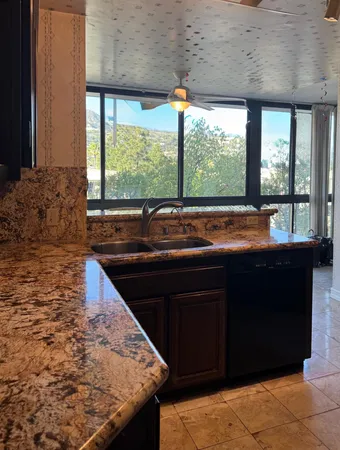 a kitchen with a sink and large window
