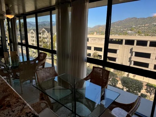 a view of a chairs and table in a balcony