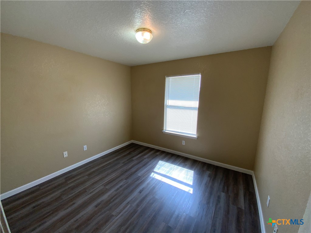 2602 Edgefield Street, Unit B Killeen, TX 76549 - Photo 12 of 12 a view of an empty room with wooden floor and a window