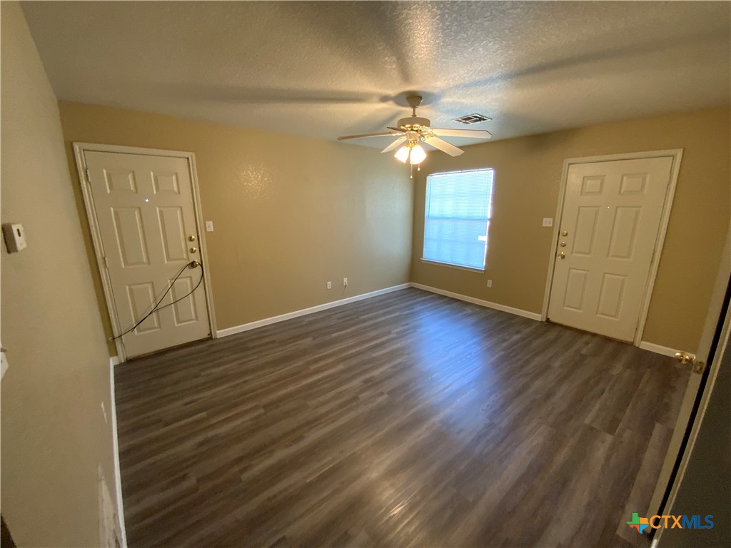 2602 Edgefield Street, Unit B Killeen, TX 76549 - Photo 7 of 12 a view of an empty room with wooden floor and a window