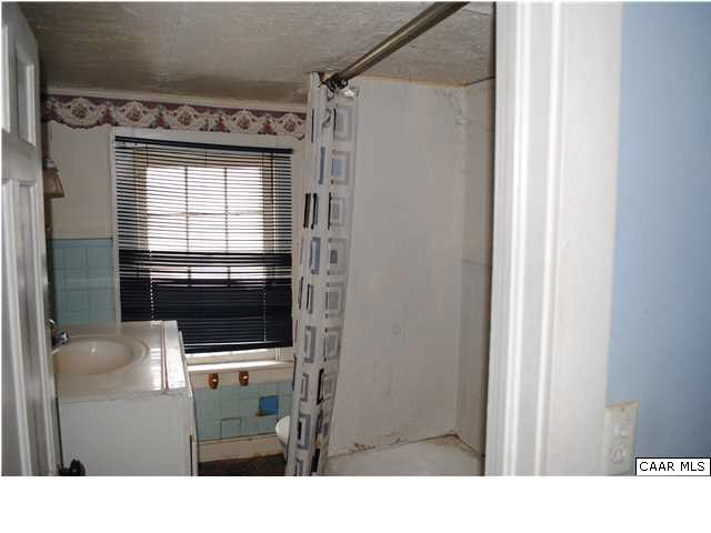 870 Black Cat Road Keswick, VA 22947 - Photo 14 of 18 a bathroom with a sink and a mirror