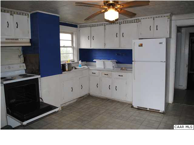 870 Black Cat Road Keswick, VA 22947 - Photo 2 of 18 a kitchen with cabinets and a stove with wooden floor