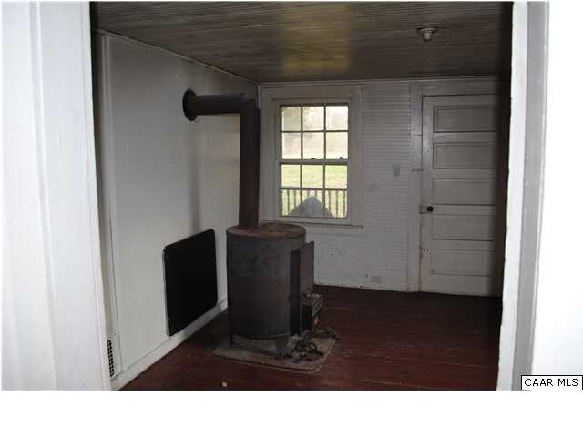 870 Black Cat Road Keswick, VA 22947 - Photo 3 of 18 a black and white room with wooden floor