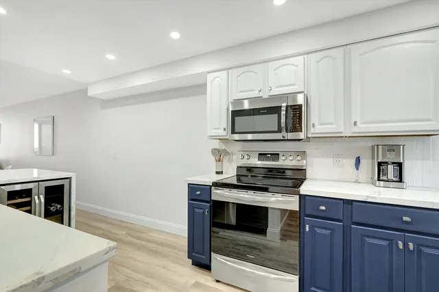 a view of a house with a yard and potted plants