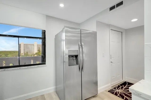 a workspace room with furniture and a potted plant