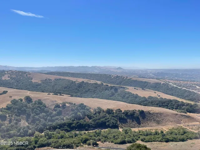 a view of an ocean beach and mountain
