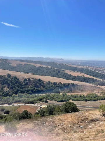 a view of an ocean beach and mountain