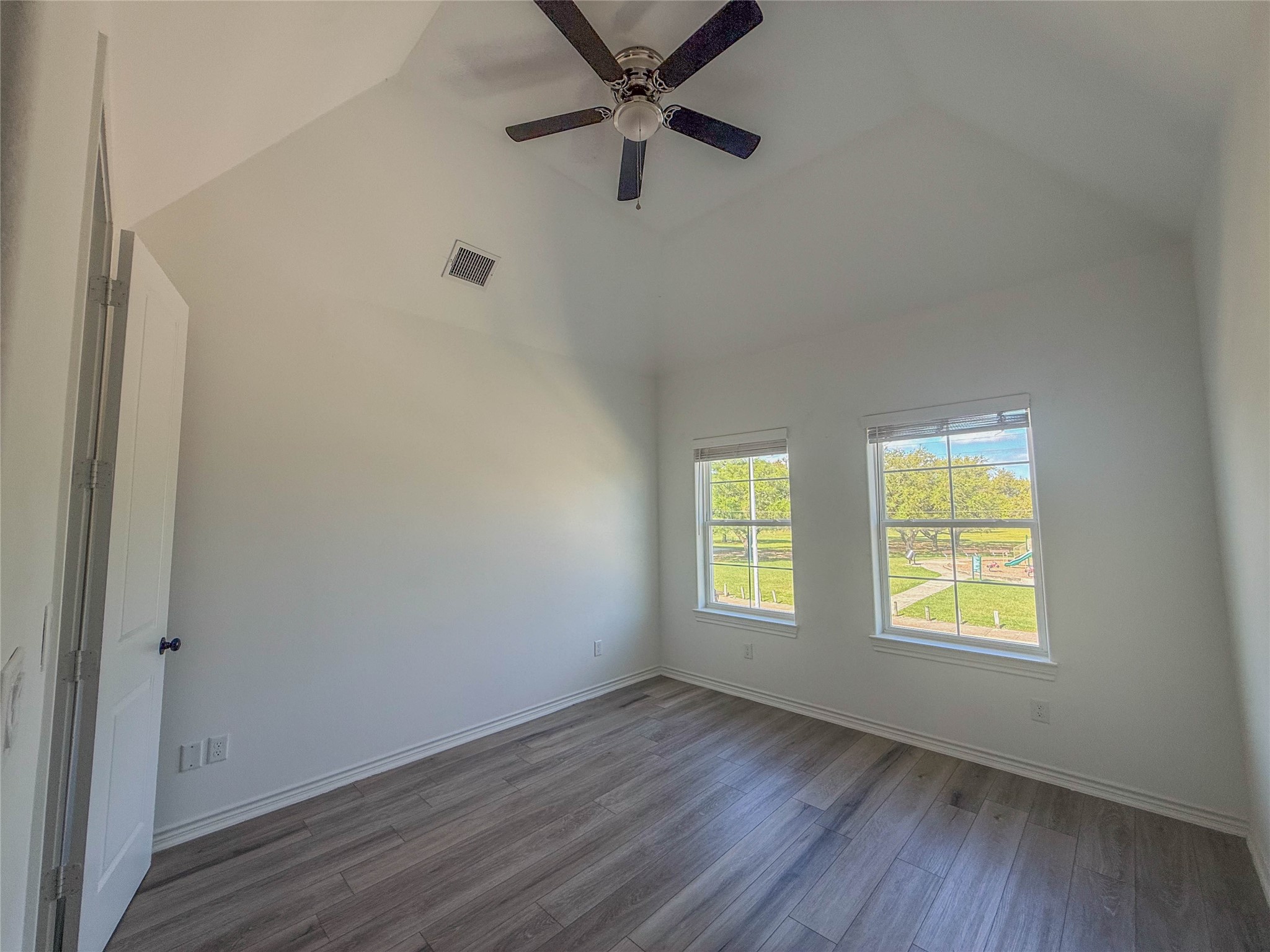 3233 Real Street, Unit A Houston, TX 77087 - Photo 11 of 12 a view of an empty room with a window and wooden floor