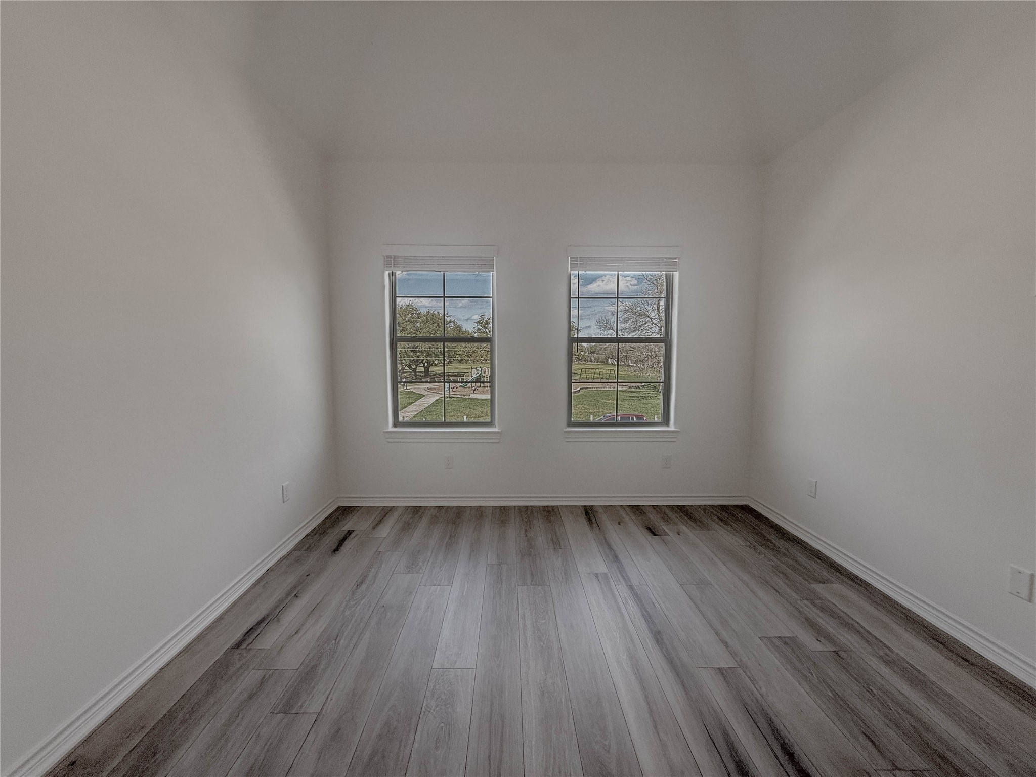 3233 Real Street, Unit A Houston, TX 77087 - Photo 10 of 12 an empty room with wooden floor and windows