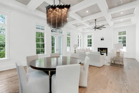 a living room with furniture a flat screen tv and a large window