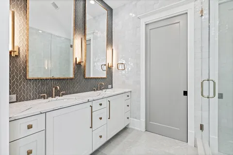 a bathroom with a shower and a sink mirror