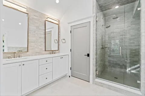 a view of a house with brick walls and a yard with plants