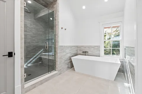 a view of a room with a tub and a floor to ceiling window