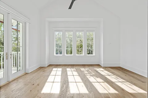 a bedroom with bed couch and window