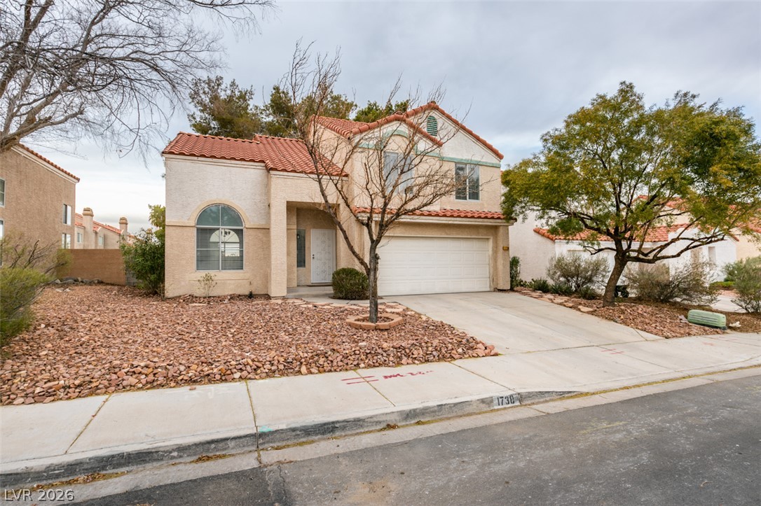 1738 Toltec Circle Henderson, NV 89014 - Photo 21 of 46 A well-maintained stucco facade with a red tile roof creates an inviting street presence.
