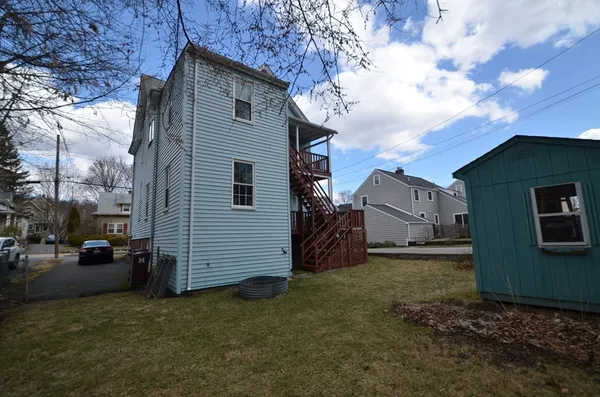 a view of a house with a backyard
