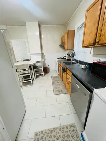 a kitchen with a sink appliances and cabinets