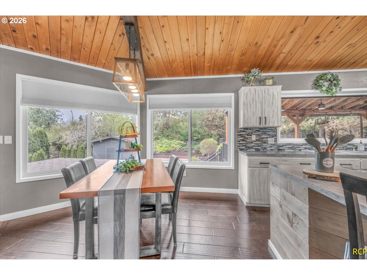59887 Westhill Road St. Helens, OR 97051 - Photo 6 of 44 a dining room with furniture a chandelier and wooden floor