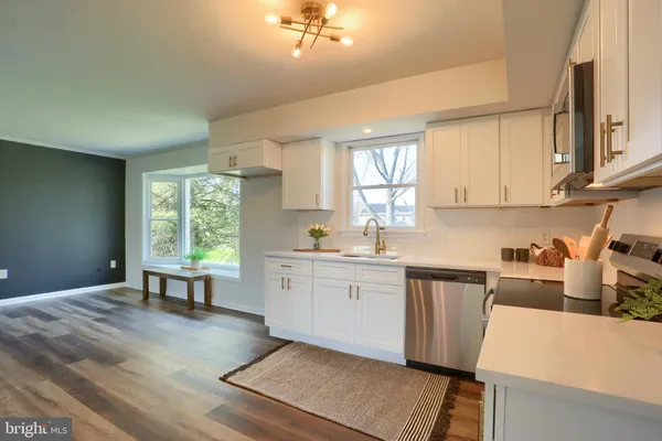 a kitchen with appliances cabinets and a window