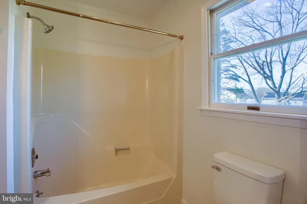 a bathroom with a bathtub and shower
