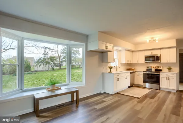 a kitchen with a sink stainless steel appliances and cabinets