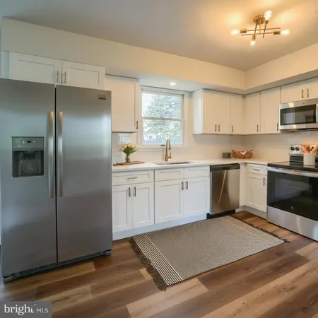 a kitchen with a sink stove and microwave
