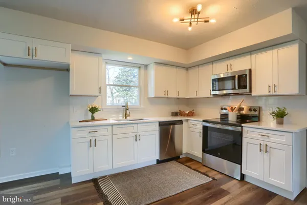 a kitchen with a sink cabinets and window