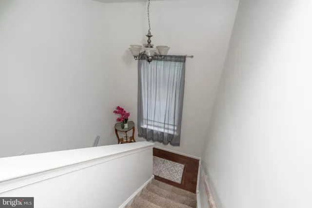 a view of a hallway with a chandelier