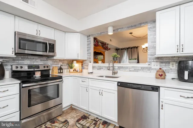 a kitchen with a sink stove and microwave