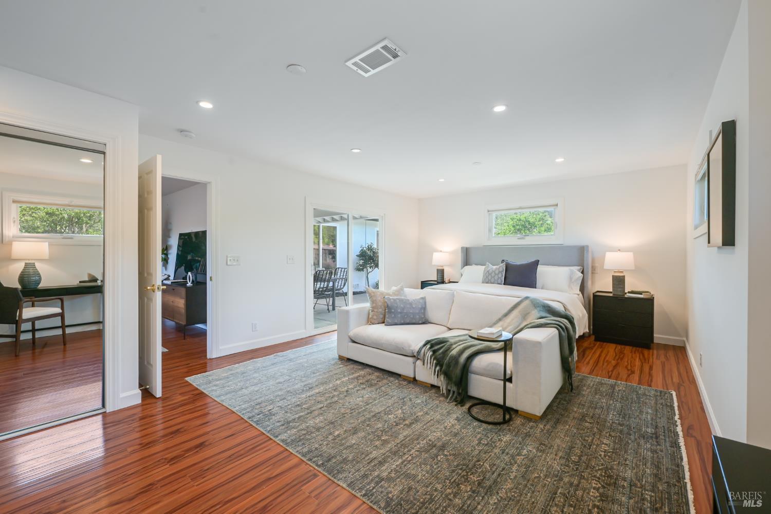 16 Wallace Way San Rafael, CA 94903 - Photo 20 of 44 a bedroom with a bed lamps and wooden floor