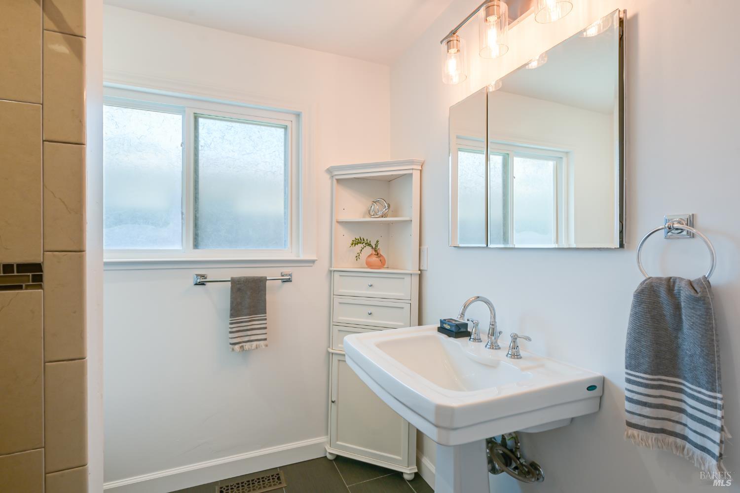 16 Wallace Way San Rafael, CA 94903 - Photo 25 of 44 a bathroom with a sink and a mirror