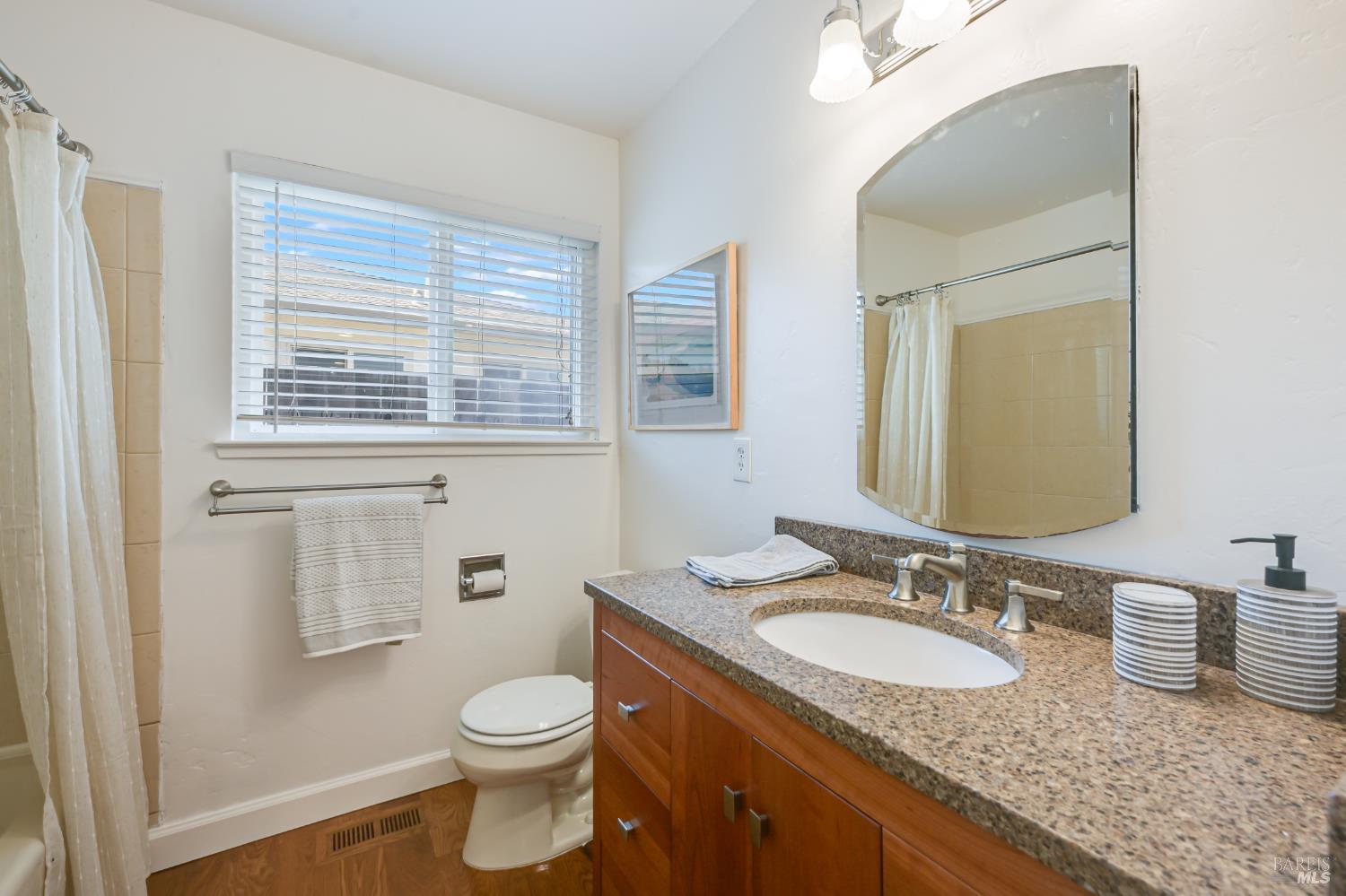 16 Wallace Way San Rafael, CA 94903 - Photo 30 of 44 a bathroom with a granite countertop sink toilet and mirror