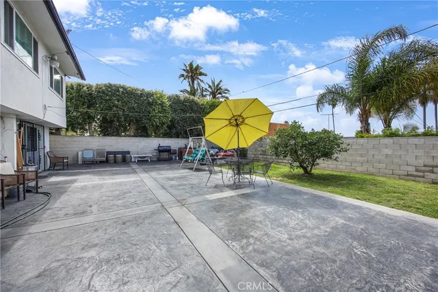a view of a chairs and table in the back yard of the house