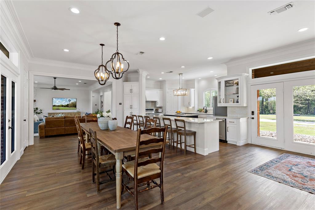 5000 Stillhouse Road Paris, TX 75460 - Photo 12 of 40 a view of a dining room and livingroom with furniture wooden floor a rug a chandelier
