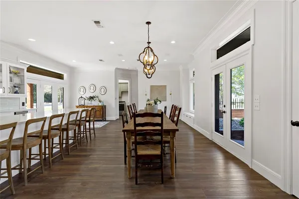 a view of a a dining room with furniture window and wooden floor