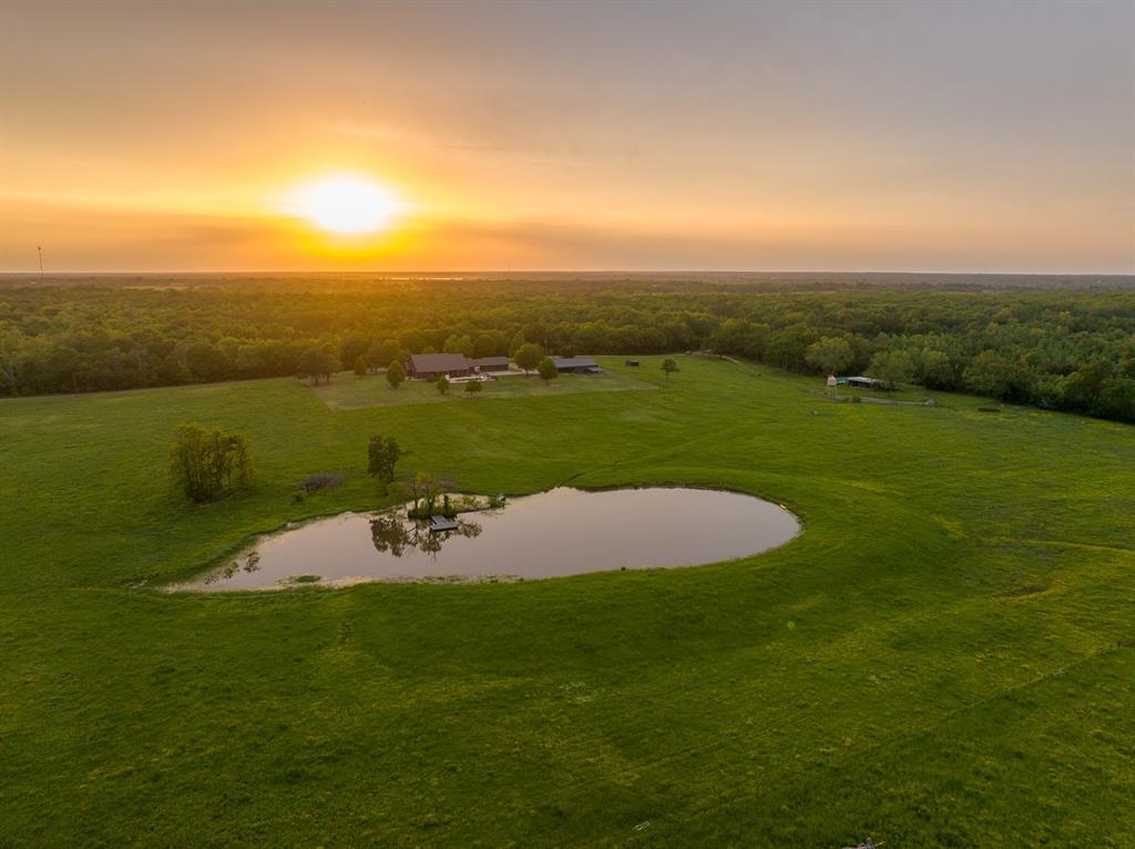 5000 Stillhouse Road Paris, TX 75460 - Photo 2 of 40 a view of a lake with a yard