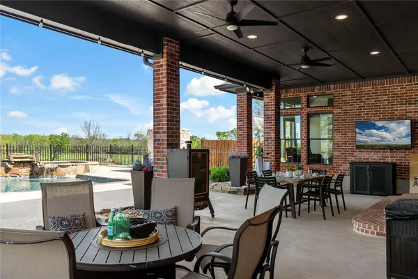 a view of a dining room with furniture fire place and outdoor kitchen