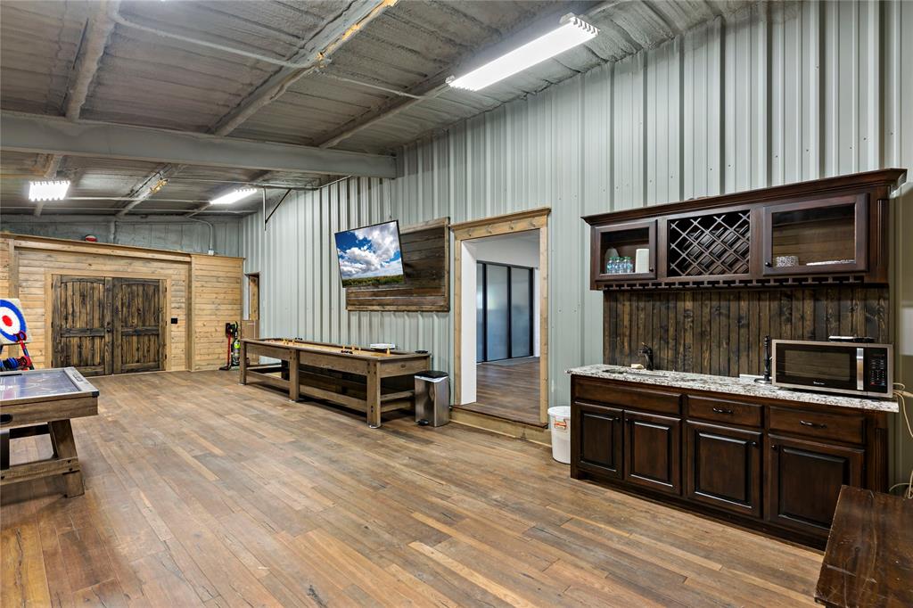 5000 Stillhouse Road Paris, TX 75460 - Photo 33 of 40 a kitchen with sink a microwave a stove and furniture
