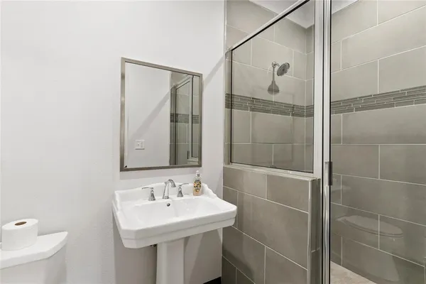 a bathroom with a sink toilet and shower