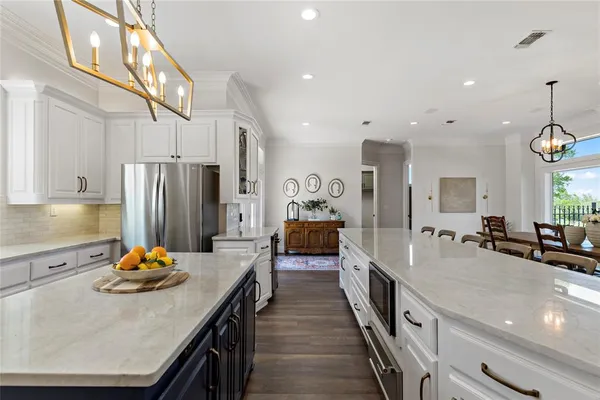 a large kitchen with stainless steel appliances lots of counter space and refrigerator