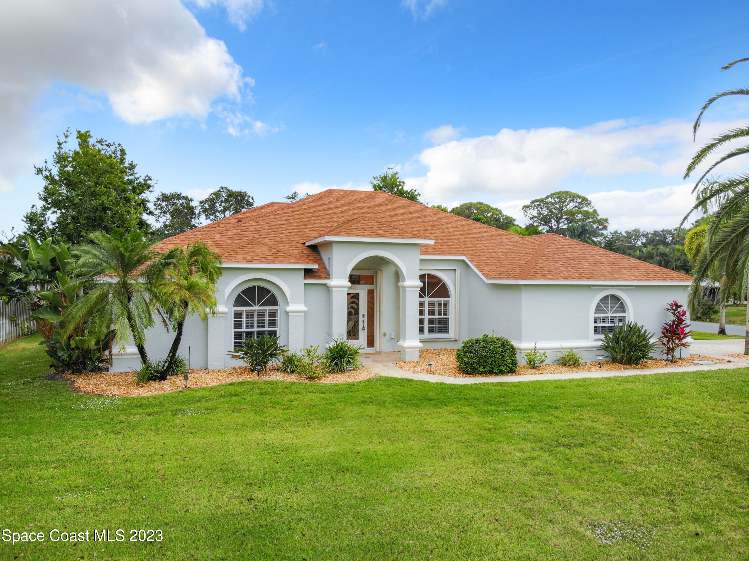 a front view of house with yard and green space
