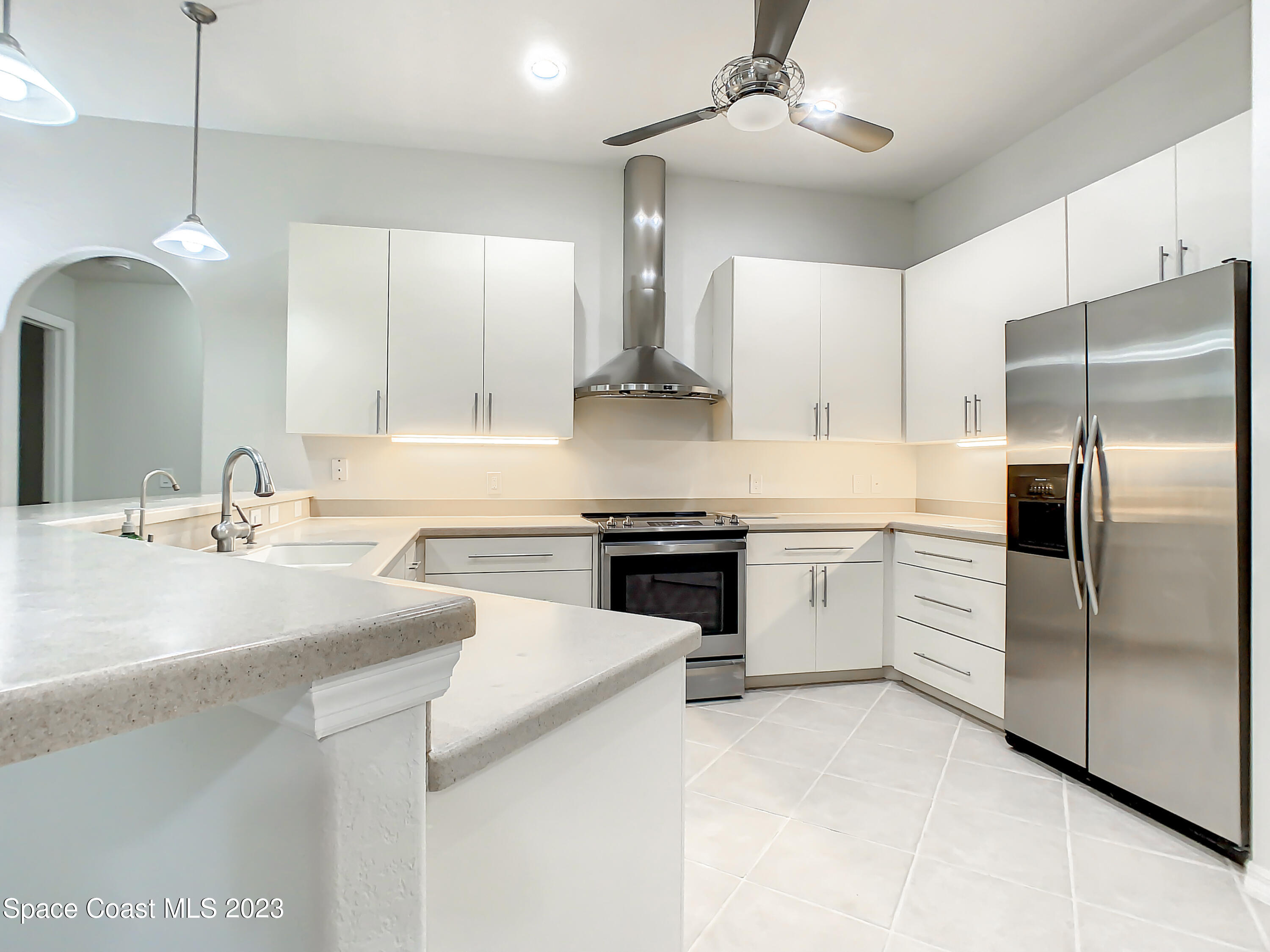 1965 Gates Road Merritt Island, FL 32952 - Photo 11 of 54 a kitchen with a sink stainless steel appliances and cabinets